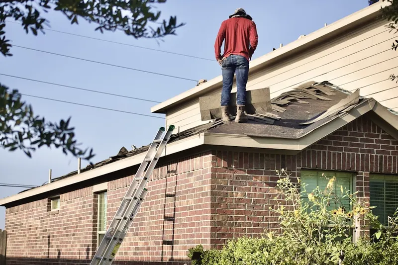 Professional roofer working on a residential roof in Union Ridge